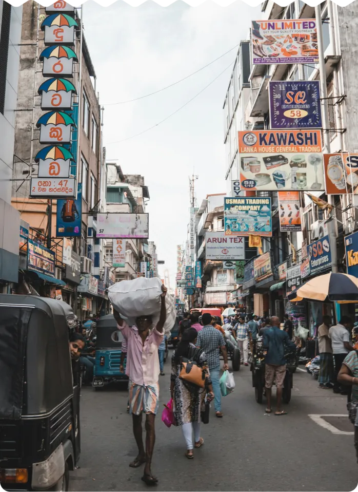 A busy shopping street lined with colourful signs